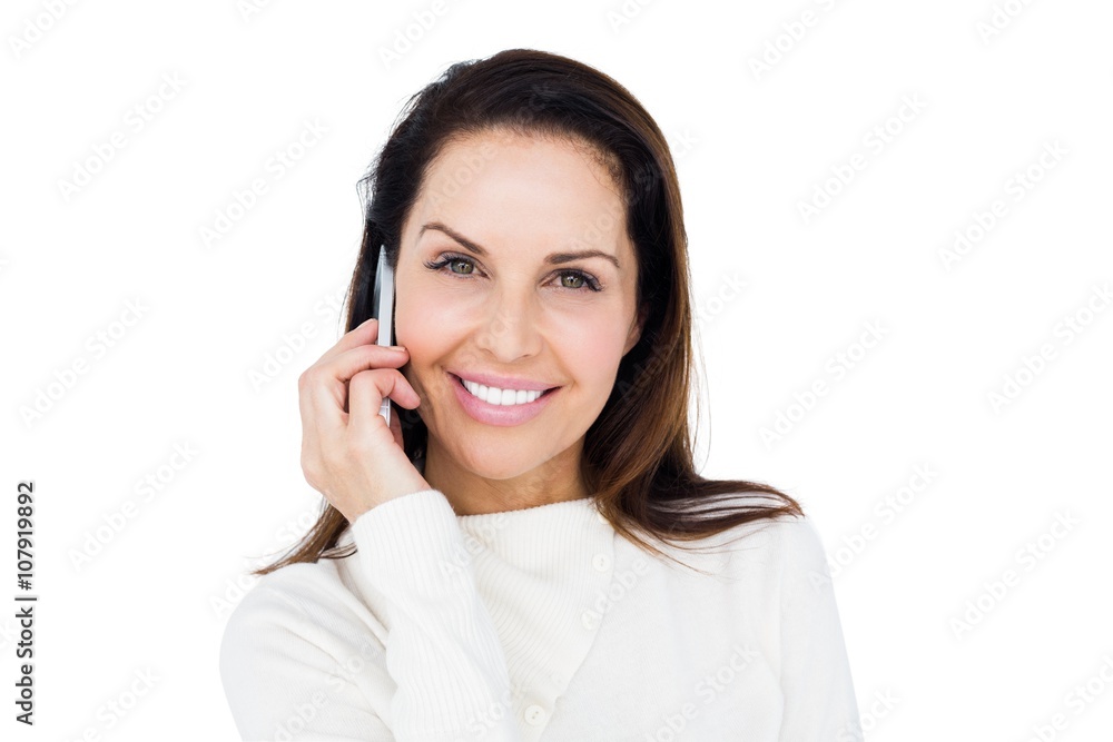 Cheerful brunette with her mobile phone calling someone Cheerful brunette with her mobile phone calling someone