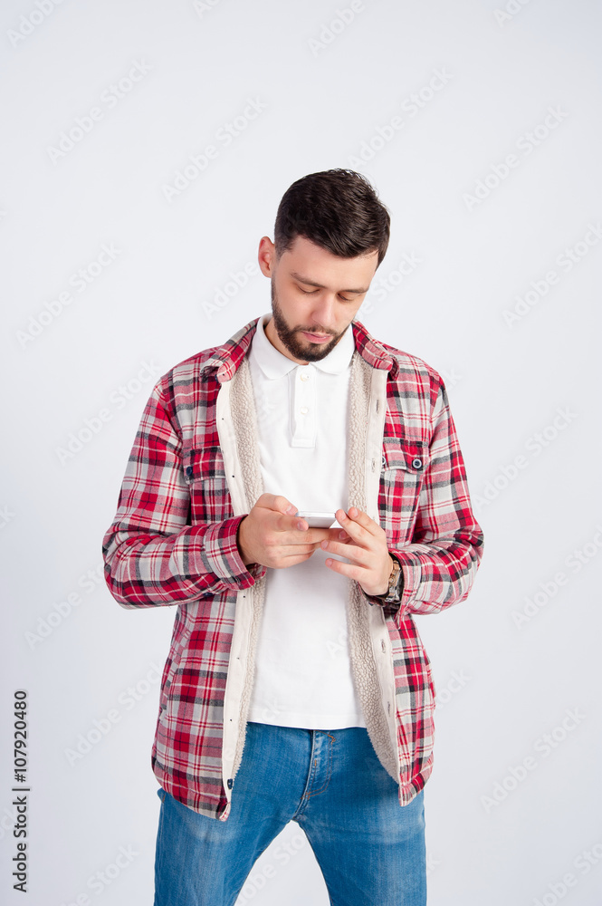 A young boy looks at the phone A young boy looks at the phone