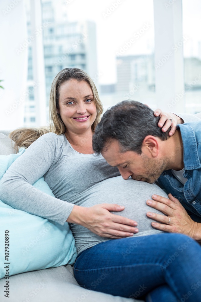 Man kissing pregnant womans stomach Man kissing pregnant womans stomach