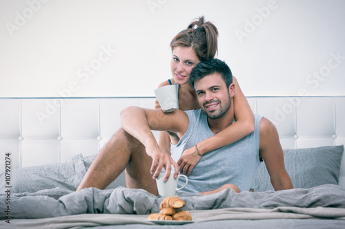 Young couple have breakfast in bed in the morning