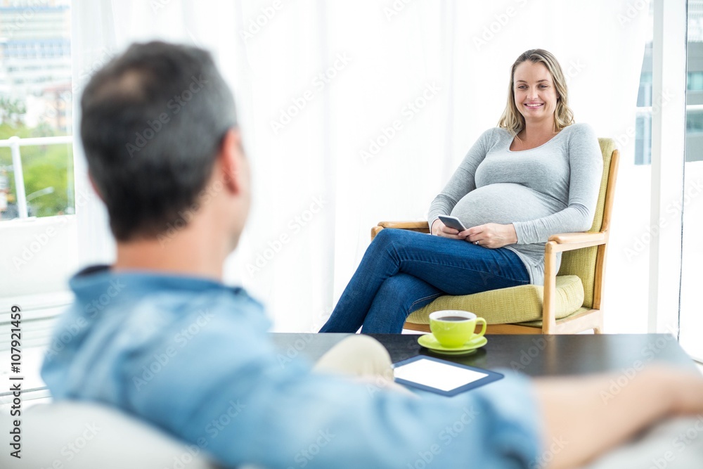 Fototapeta premium Pregnant woman using smartphone