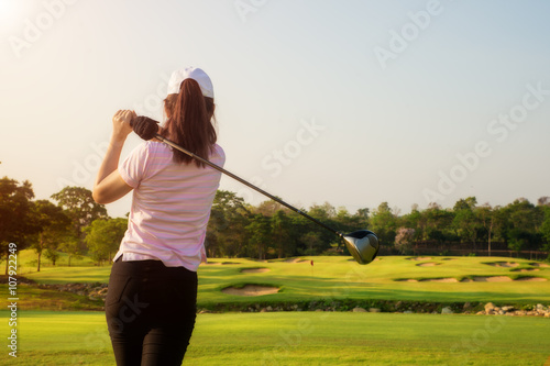 Asian woman golfer hit sweeping golf course in the summer