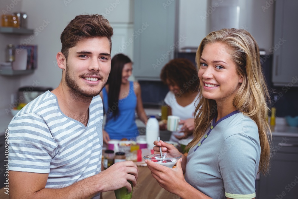 Portrait of smiling friends having breakfast 