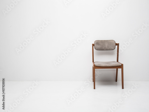 Fototapeta Naklejka Na Ścianę i Meble -  White wall texture with a chair