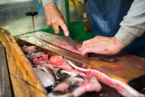 slicing unagi japanese eel fish for sell at Tsukiji seafood market, Japan