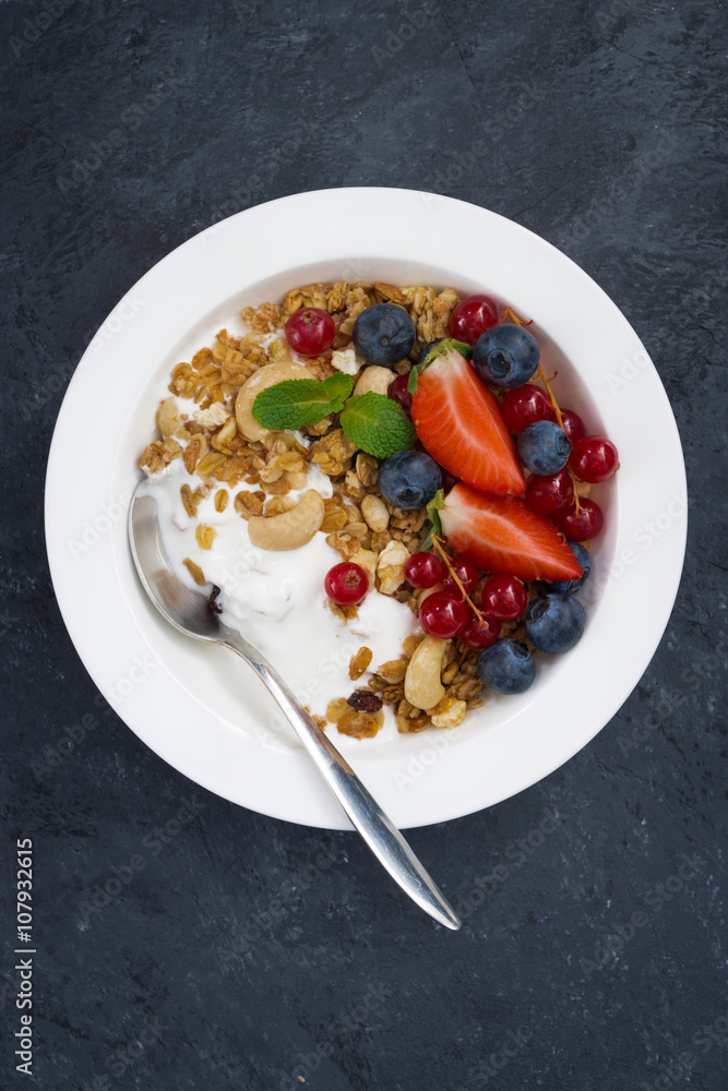 Baked muesli with fresh berries and yogurt, vertical, top view Baked muesli with fresh berries and yogurt, vertical, top view