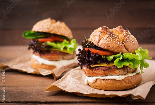 Big sandwich - hamburger with juicy turkey burger, cheese, tomato and tartar sauce