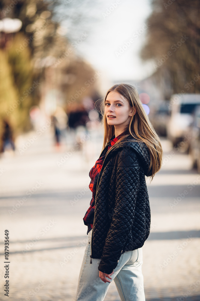 Girl standing on the street with sunset background Girl standing on the street with sunset background