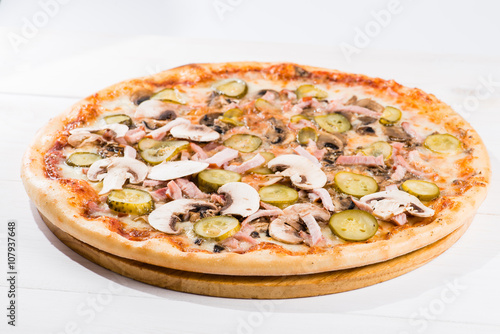 tasty pizza on a white wooden background