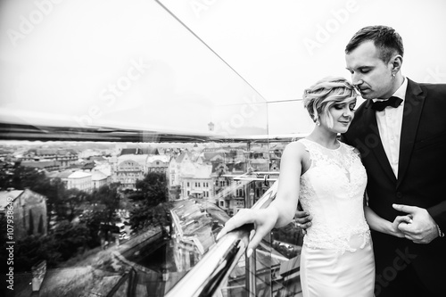 groom holds the hand of his beautiful woman photo