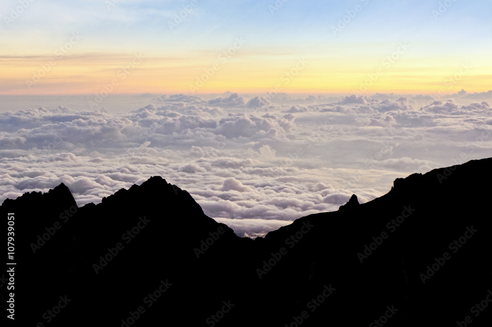 Colourful of sunrise scene with mist on silhouette of mount Kinabalu. Twilight light.