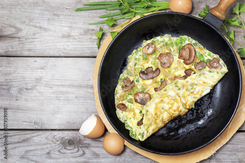 French omelet with herbs, stuffed with mushrooms and onions