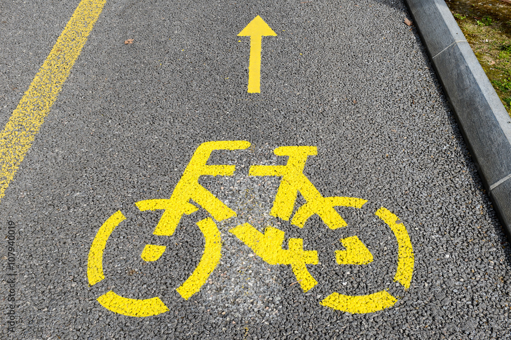 Yellow arrows and bicycle sign of a cycling path Yellow arrows and bicycle sign of a cycling path
