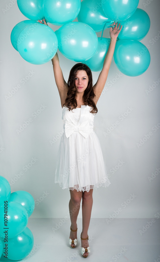 beautiful curly girl in a white dress and sunglasses in the style of disco playing with balloons beautiful curly girl in a white dress and sunglasses in the style of disco playing with balloons