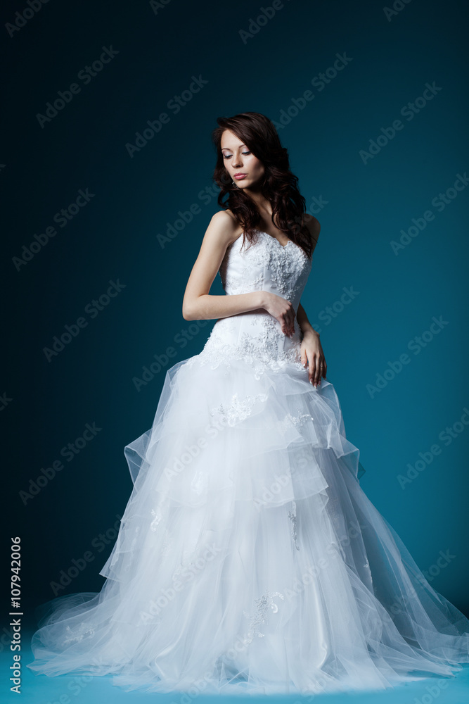beautiful bride in wedding dress on blue beautiful bride in wedding dress on blue