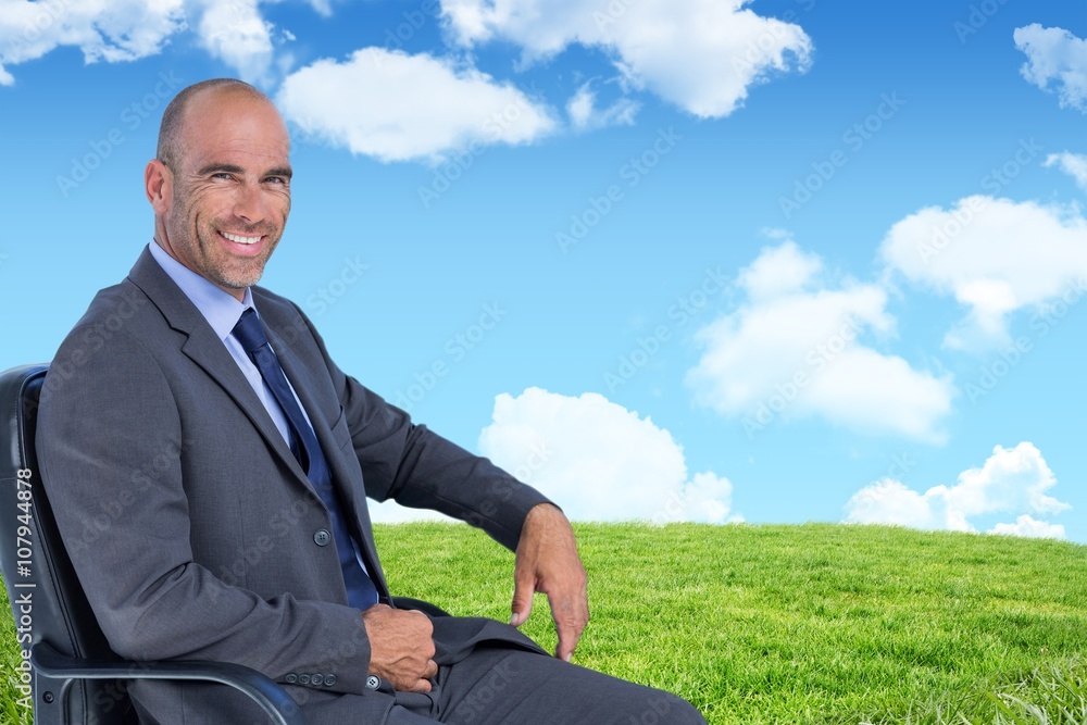 Composite image of portrait of confident businessman sitting Composite image of portrait of confident businessman sitting