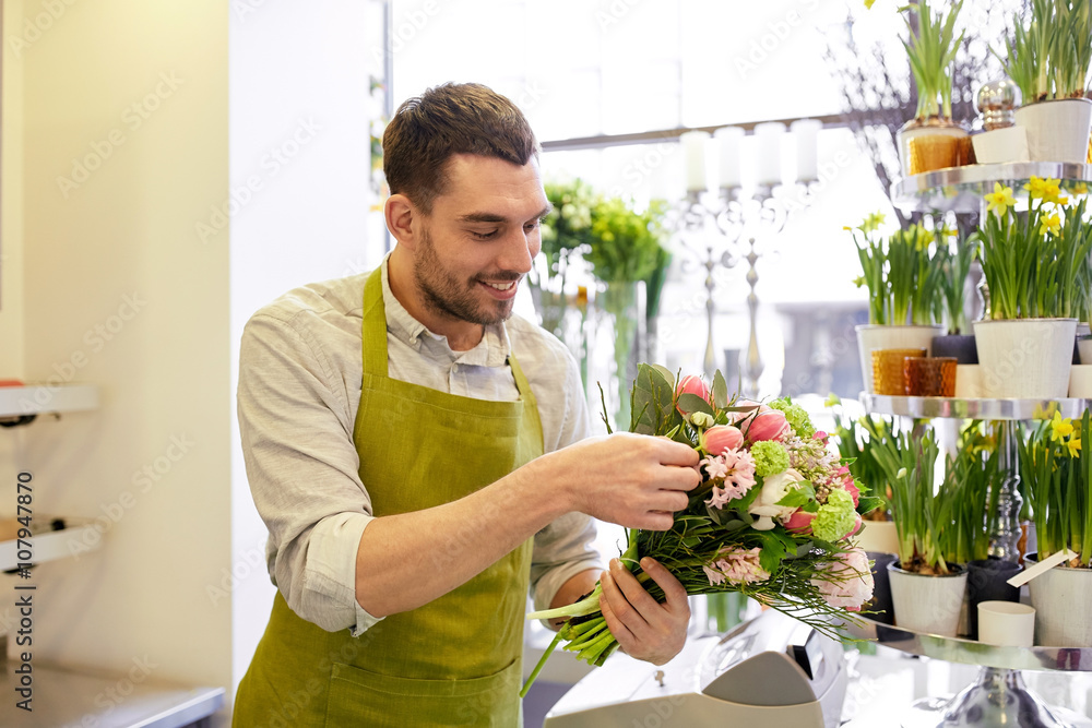 smiling florist man making bunch at flower shop smiling florist man making bunch at flower shop