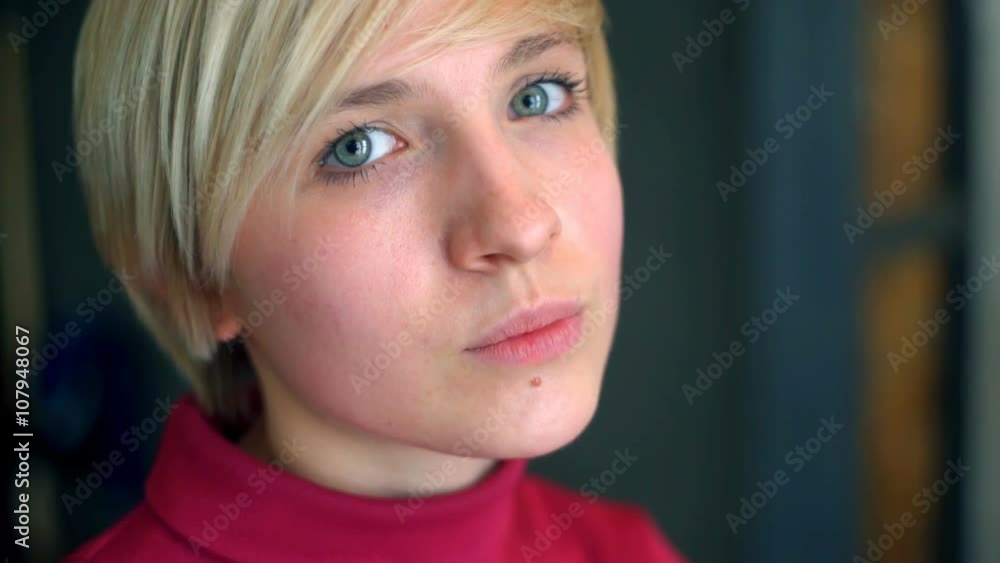 portrait of a blond short haired young female in pink shirt portrait of a blond short haired young female in pink shirt
