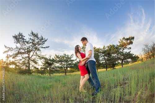 Happy young couple embrace in park