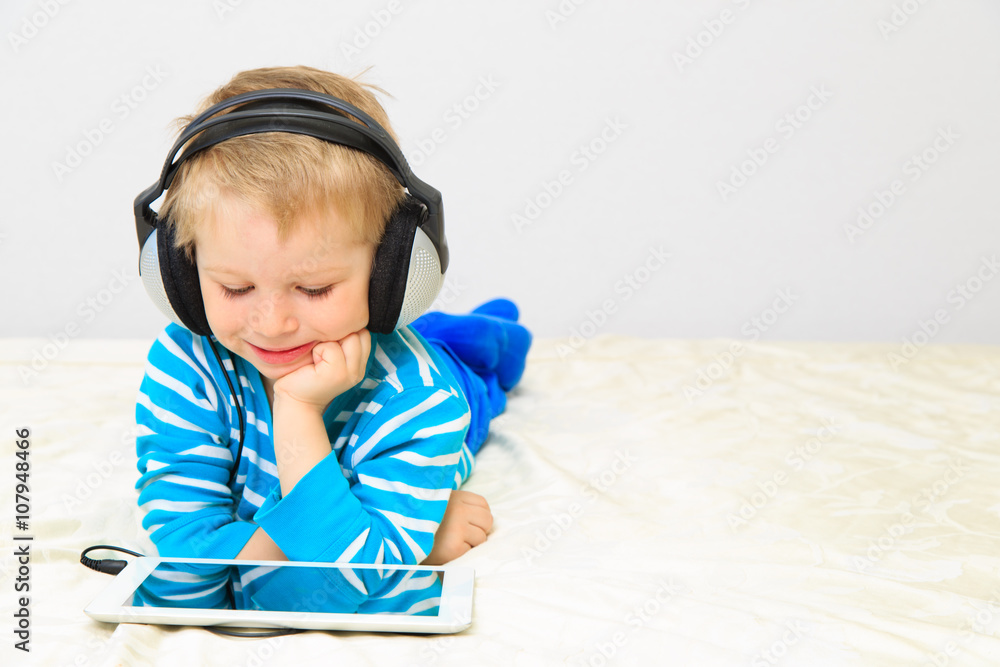little boy with headset using touch pad little boy with headset using touch pad