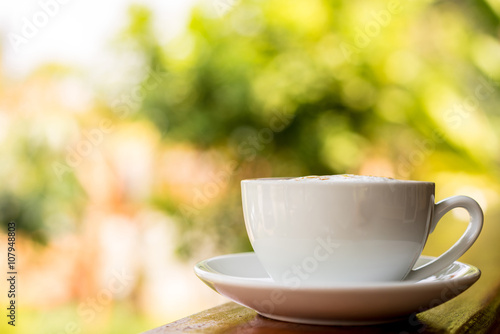 coffee cup on wooden table  soft focus