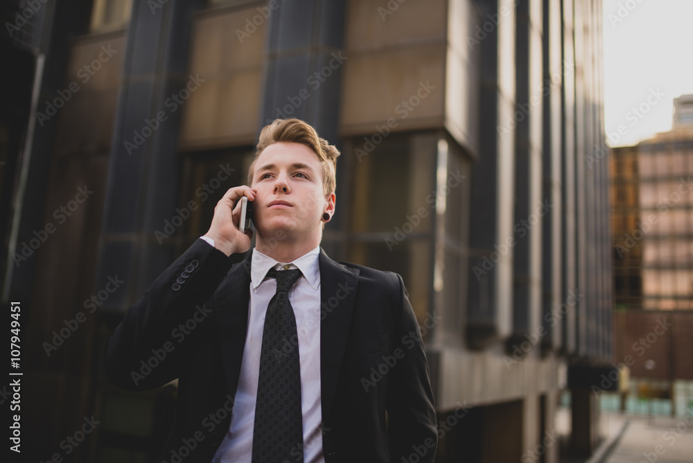 Businessman using the phone on the street Businessman using the phone on the street