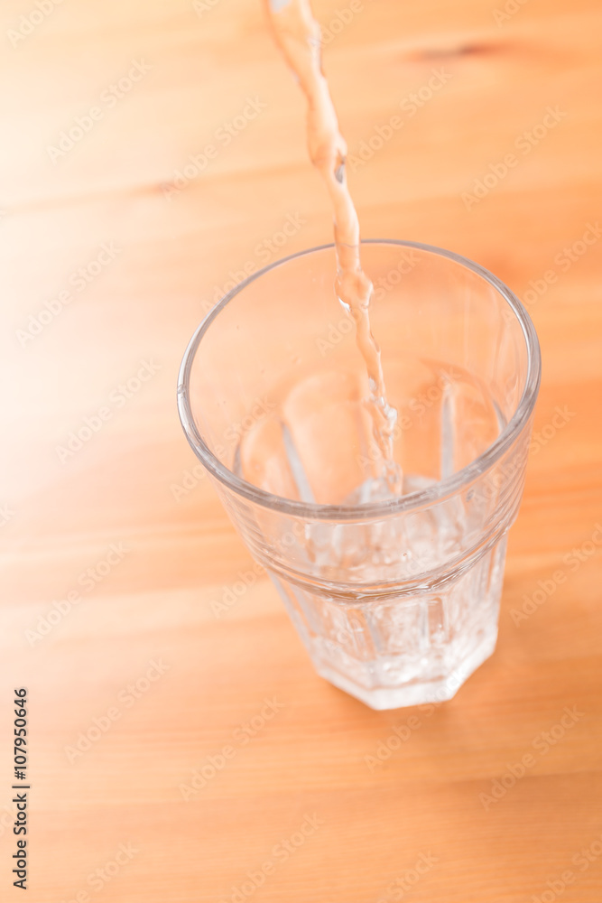 Pouring water to glass