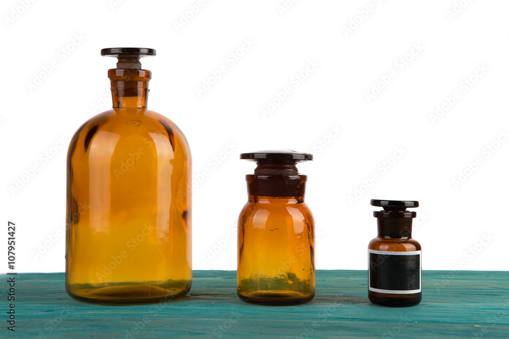 medicine bottles on wooden table isolated