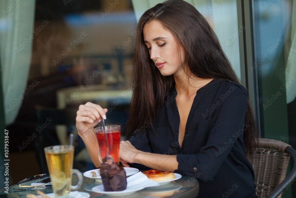 pretty young woman sitting in cafe with a cup of tea or coffee outdoor. Charming woman in a restaurant. Woman with coffee and cake. Woman portrait indoors. pretty young woman sitting in cafe with a cup of tea or coffee outdoor. Charming woman in a restaurant. Woman with coffee and cake. Woman portrait indoors.