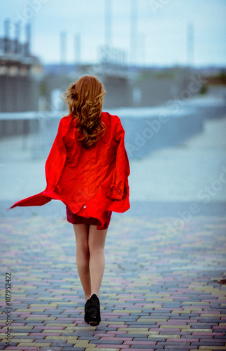 Redhead girl is walking on the heels