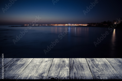 View of Cyprus town over old light wooden table or board. Collag