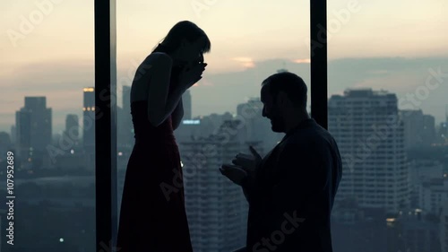 Couple at home, man surprises his girlfriend with marriage proposal 
