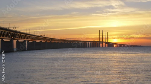 Oresundsbron at sunset. The bridge between Sweden and Denmark. Cars drive over the bridge