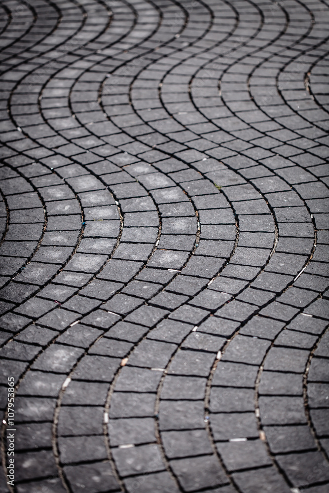 Grey pavement waves shape handmade sidewalk closeup Grey pavement waves shape handmade sidewalk closeup