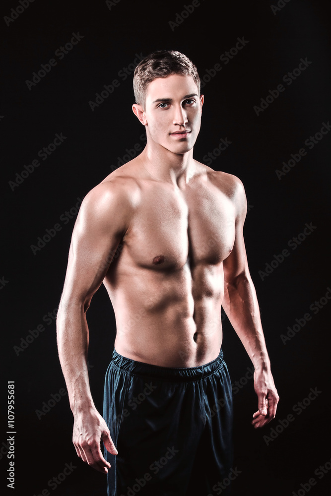 Fototapeta premium Fitness boy on black background