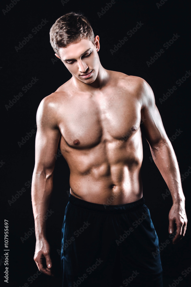 Fitness boy on black background