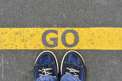 Top View of Male shoes on the asphalt road with yellow line and