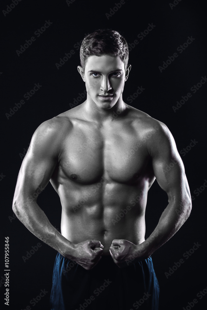 Fototapeta premium Fitness boy on black background