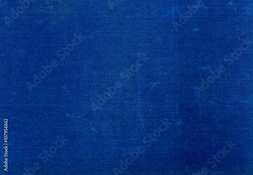Grungy blue textile surface with scratches.