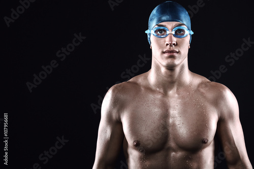 Fitness swimmer on black background
