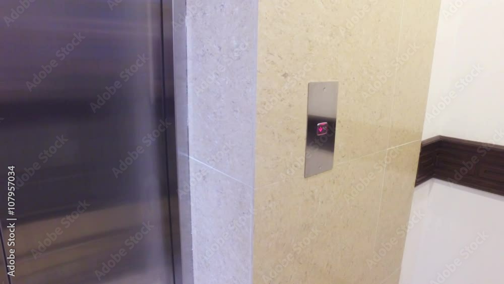 woman's hand pushes the elevator button woman's hand pushes the elevator button