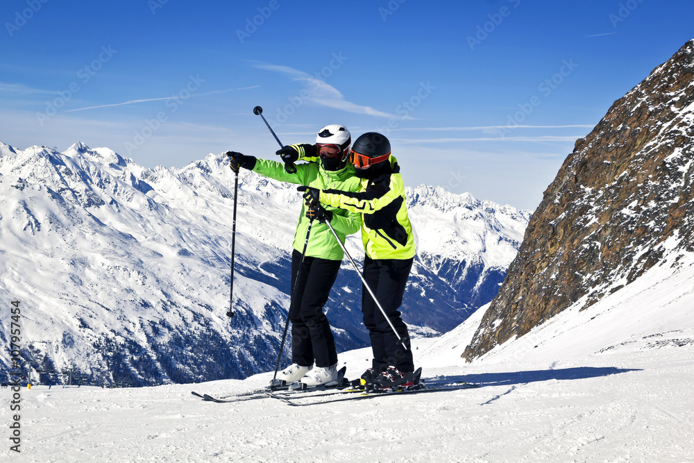 Young happy couple in snowy mountains