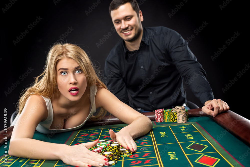 Couple playing roulette wins at the casino. Couple playing roulette wins at the casino.