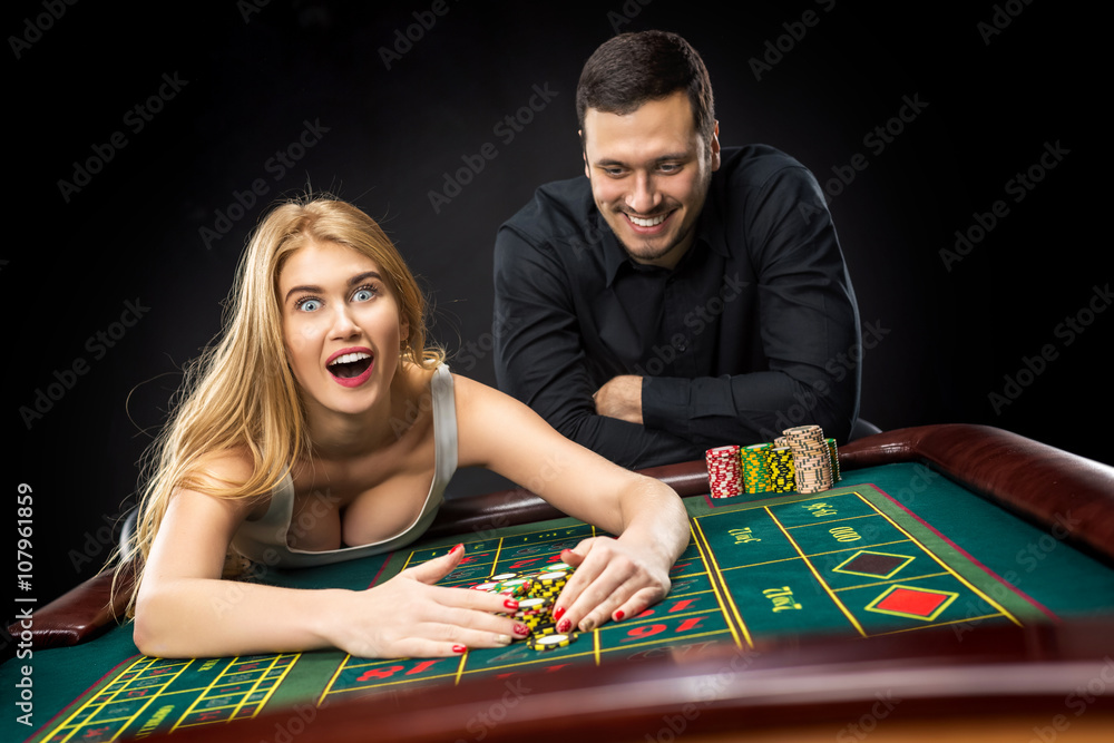 Couple playing roulette wins at the casino. Couple playing roulette wins at the casino.