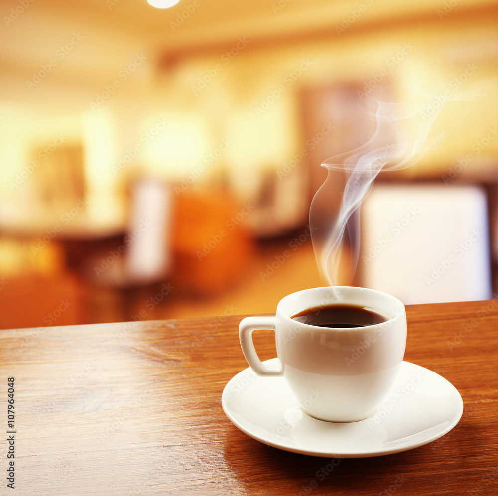 Cup of coffee on table on blured cafe background Cup of coffee on table on blured cafe background