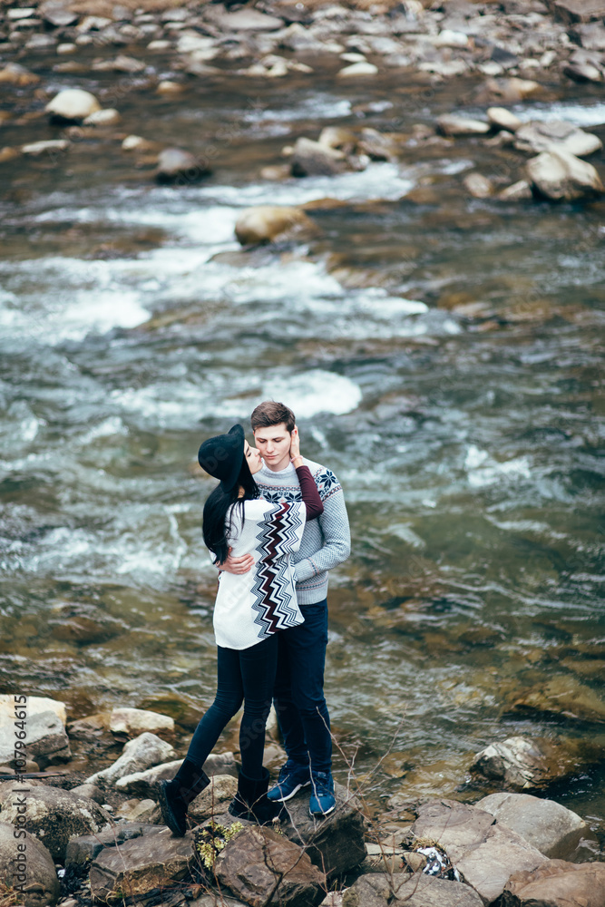 guy and girl along a mountain river