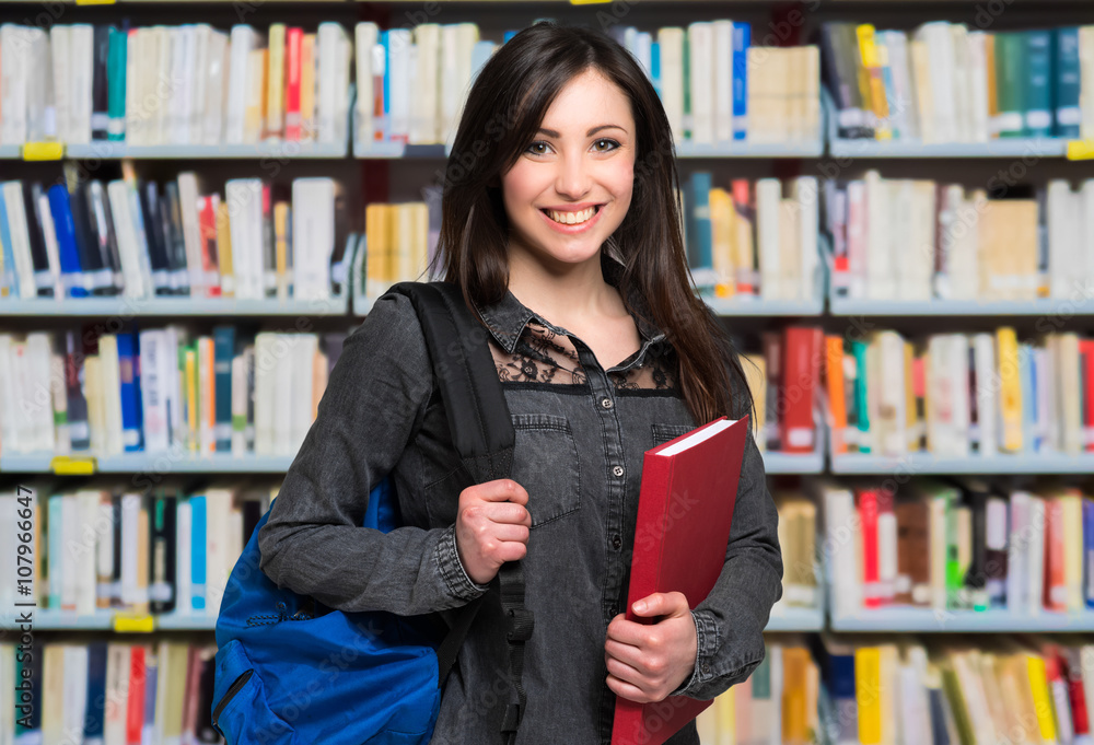 Portrait of a beautiful student in a library Portrait of a beautiful student in a library