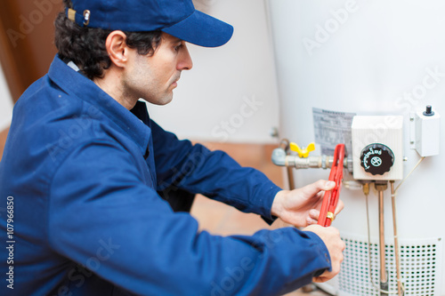 Plumber fixing an hot-water heater