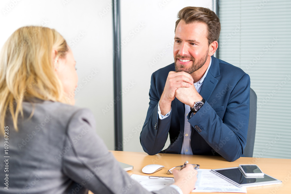 Young attractive employer doing a job interview to a woman Young attractive employer doing a job interview to a woman