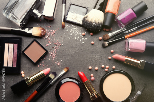 Frame of decorative cosmetics and accessories for makeup on grey background